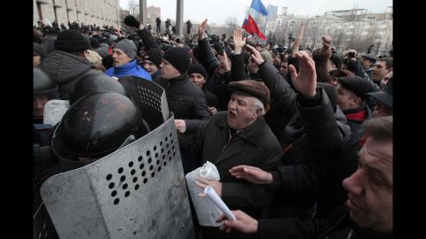 Demonstrators break a police barrier as they storm a regional administrative building in Donetsk on March 5.