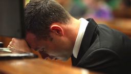 Oscar Pistorius lowers his head on day three of his murder trial in Pretoria, South Africa, March 5.