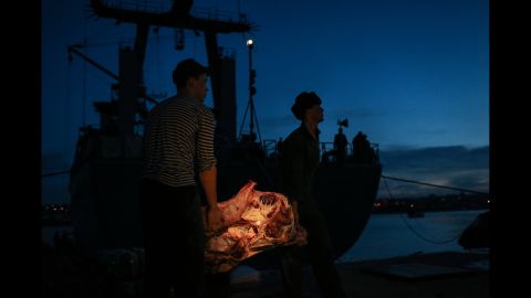 Ukrainian sailors carry meat to their vessel in the Sevastopol harbor on March 5.