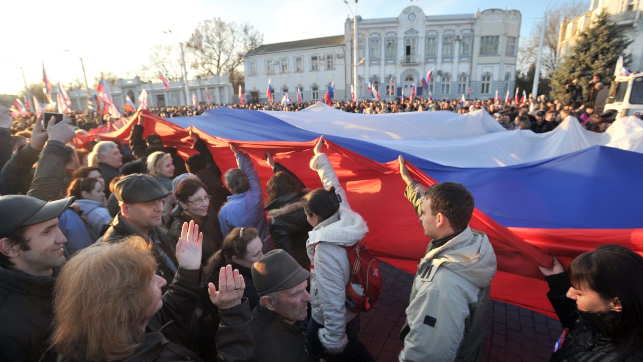 Pro-Russian activists carry a huge Russian flag during their rally in the western Crimean city of Yevpatoria on March 5, 2014.
