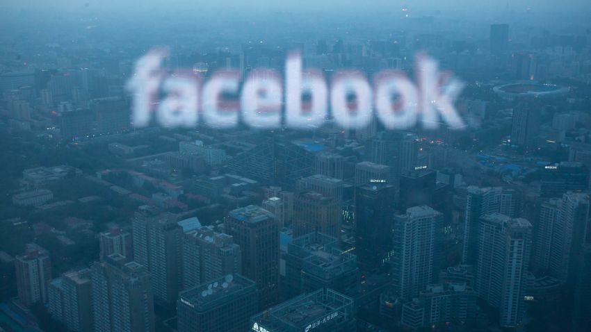 A photo taken on May 16, 2012 shows a computer screen displaying the logo of social networking site Facebook reflected in a window before the Beijing skyline. With investors hungry for Facebook shares ahead of a hotly anticipated offering, the social network unveiled a 25 percent increase in the number of shares to be sold at the market debut. AFP PHOTO / Ed Jones (Photo credit should read Ed Jones/AFP/GettyImages)