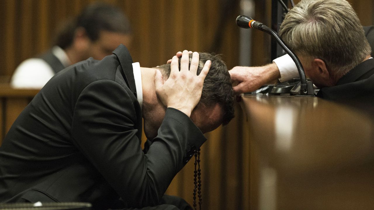 Pistorius covers his ears on Thursday, March 6, as a witness speaks about the morning Steenkamp was killed.