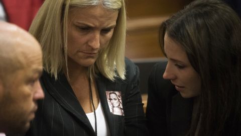 Pistorius' sister, Aimee, right, speaks with members of Steenkamp's family on March 6.