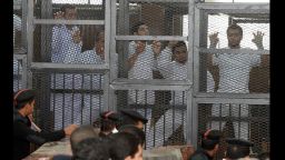Al Jazeera journalists are seen in cages during their trail at the Police Institution in Cairo, Egypt on March 5. The journalists are accused of spreading false news and belonging to "terrorist group", and broadcasting against Egypt.