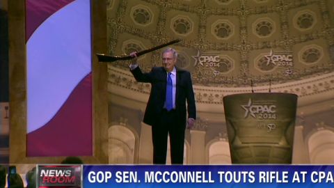 Mitch McConnell waves a rifle at CPAC