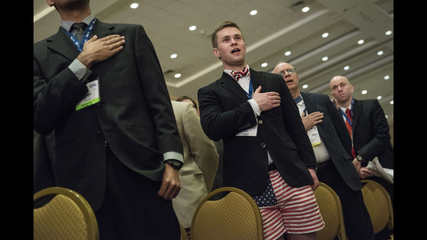 Attendees sing the National Anthem as CPAC opens on Thursday.
