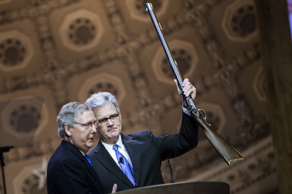 Retiring U.S. Sen. Tom Coburn, right, of Oklahoma holds a rifle given to him by Senate Minority Leader Mitch McConnell during the 2014 Conservative Political Action Conference on Thursday, March 6, in National Harbor, Maryland. Click through the images for highlights from the conference.