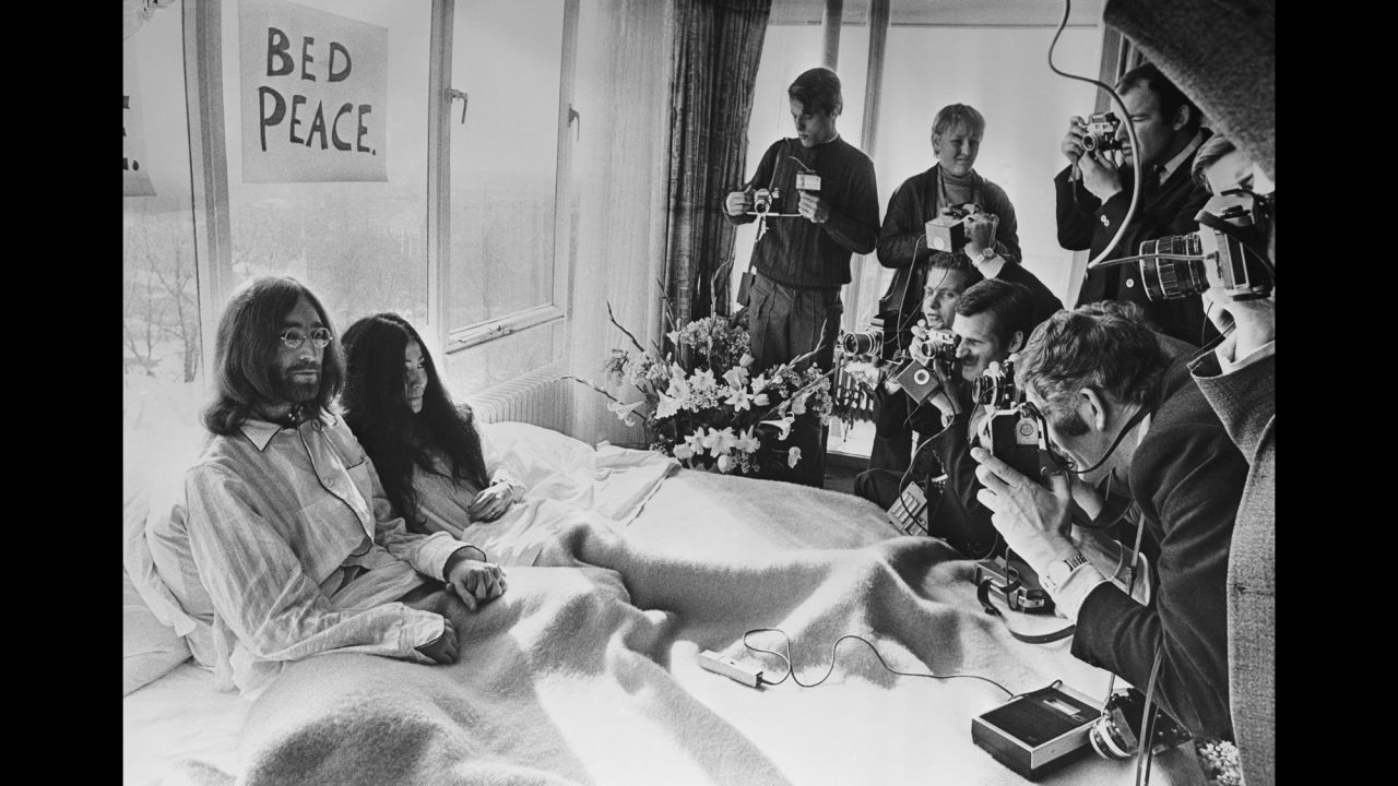 John Lennon and Yoko Ono pose for the press at their hotel in Amsterdam, Netherlands, in March 1969. The couple stayed in bed for seven days "as a protest against war and violence in the world."