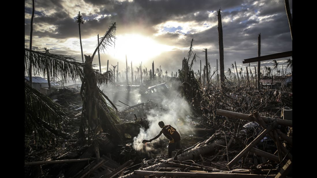 A man fans flames on a fire in Leyte, Philippines, after Typhoon Haiyan ripped through the country in November.