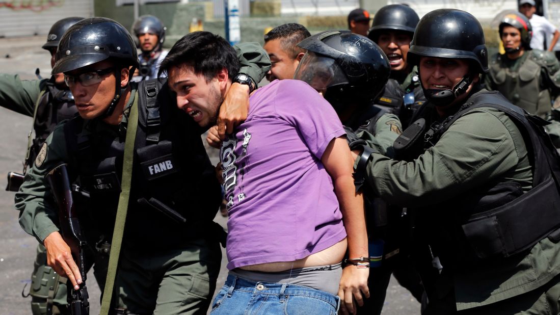 National Guard members arrest an anti-government protester during clashes in the Los Ruices neighborhood of Caracas on Thursday, March 6.