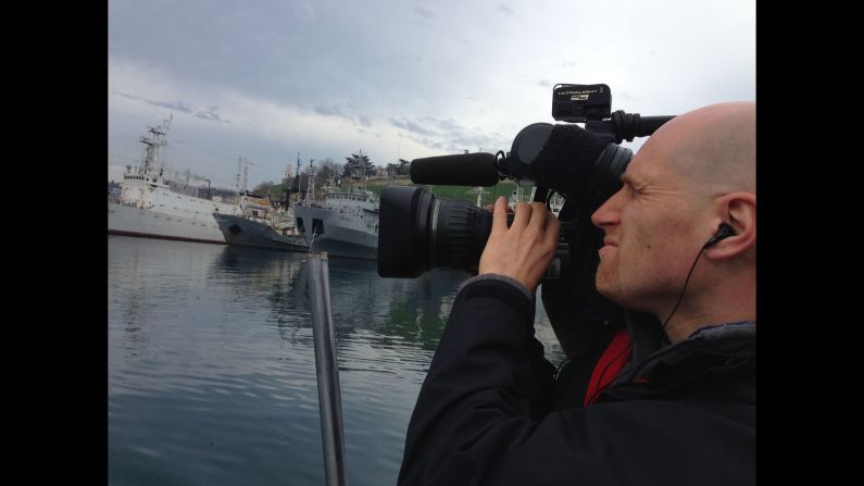 SEVASTOPOL, UKRAINE:  Cameraman Chris Jackson captures the Russian Black Sea fleet in Sevastopol on March 5.  Photo by CNN's Ben Wedeman.  Follow Ben on Instagram at <a href="https://trans.hiragana.jp/ruby/http://instagram.com/bcwedeman" target="_blank" target="_blank">instagram.com/bcwedeman</a>.