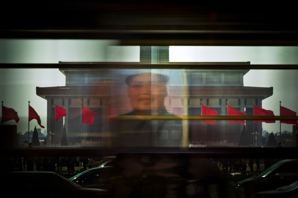 MARCH 7 - BEIJING, CHINA: Portrait of the late Communist leader Mao Zedong is reflected on a bus passing through Tiananmen Square -- the venue for the annual National People's Congress of China. The agenda is focused mainly on the key economic reforms outlined last year.