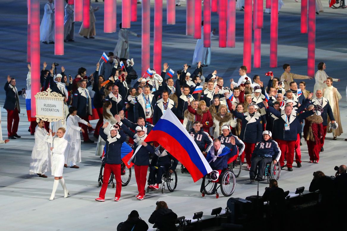 Russian athletes, led by skier and flag bearer Valerii Redkozubov, enter the stadium.