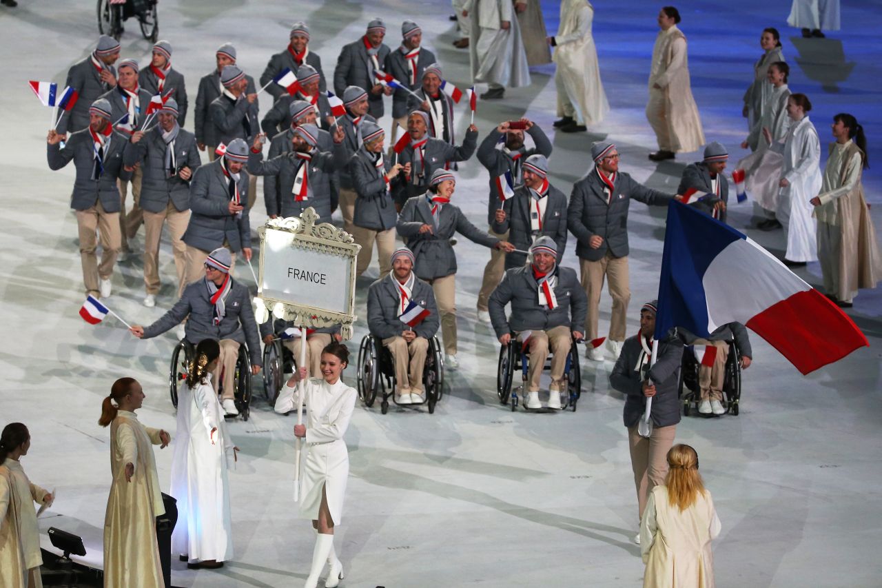 France enters the stadium led by skier and flag bearer Vincent Gauthier-Manuel.