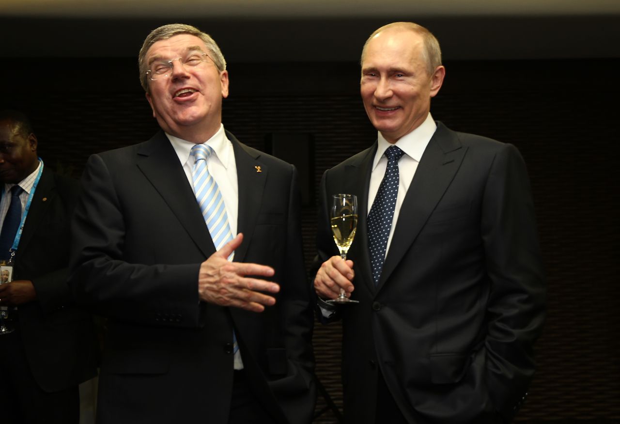 Putin, right, and International Olympic Committee President Thomas Bach laugh during the ceremony.