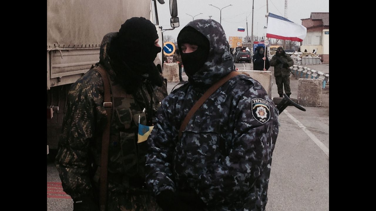 SOUTHERN UKRAINE:  Gunmen block monitors from the Organization for Security and Co-operation in Europe (OSCE) who are trying unsuccessfully to negotiate their way into Crimea past pro-Russian border patrols on March 7.  Photo by CNN's Christian Streib.  Follow Christian on Instagram at <a href="http://instagram.com/christianstreibcnn" target="_blank" target="_blank">instagram.com/christianstreibcnn</a>
