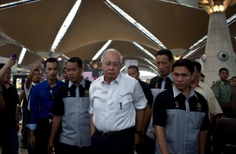 Malaysian Prime Minister Najib Razak, center, arrives to meet family members of missing passengers at the reception center at Kuala Lumpur International Airport on March 8, 2014.