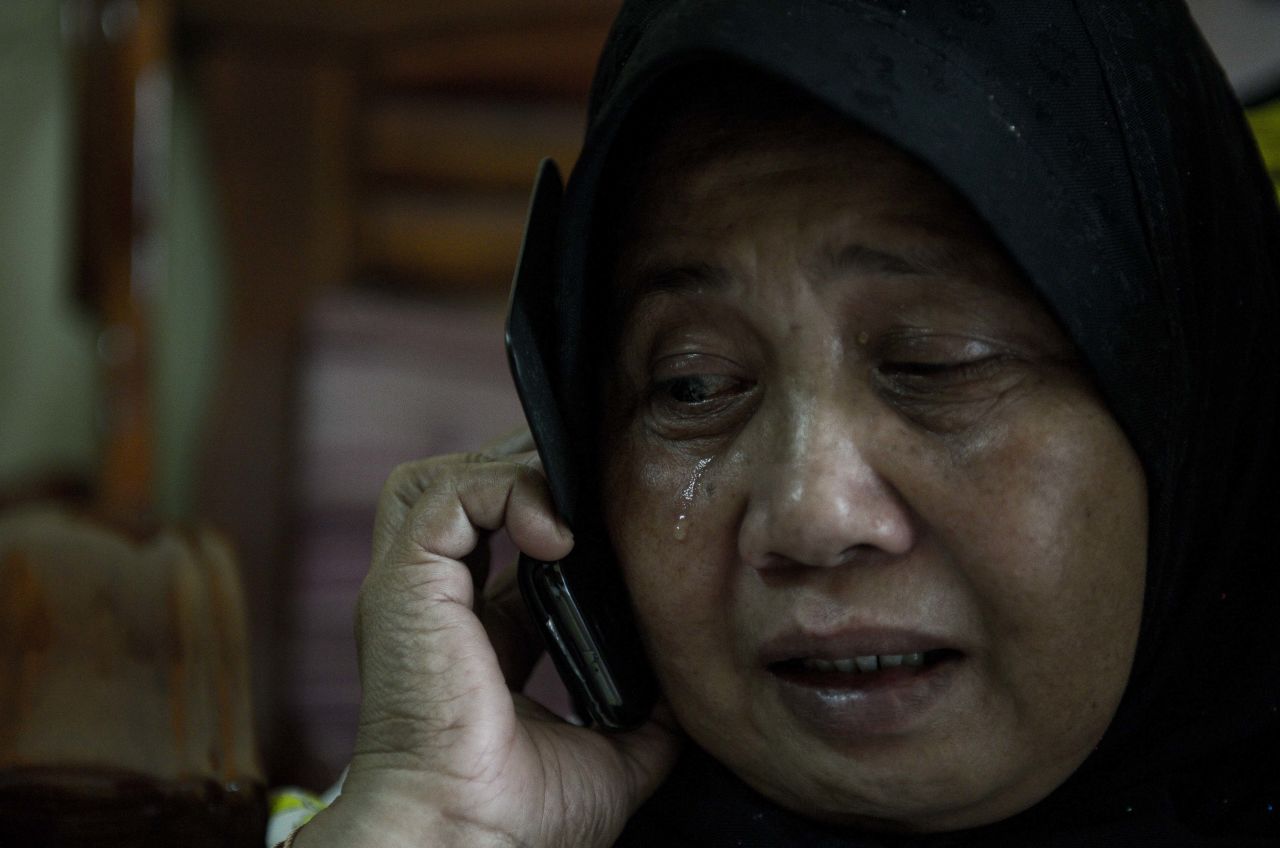 A relative of two missing passengers reacts at their home in Kuala Lumpur on March 8, 2014.