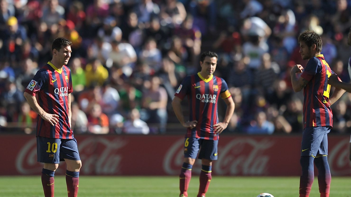 Dejected Barcelona players contemplate defeat at lowly Valladolid in La Liga.