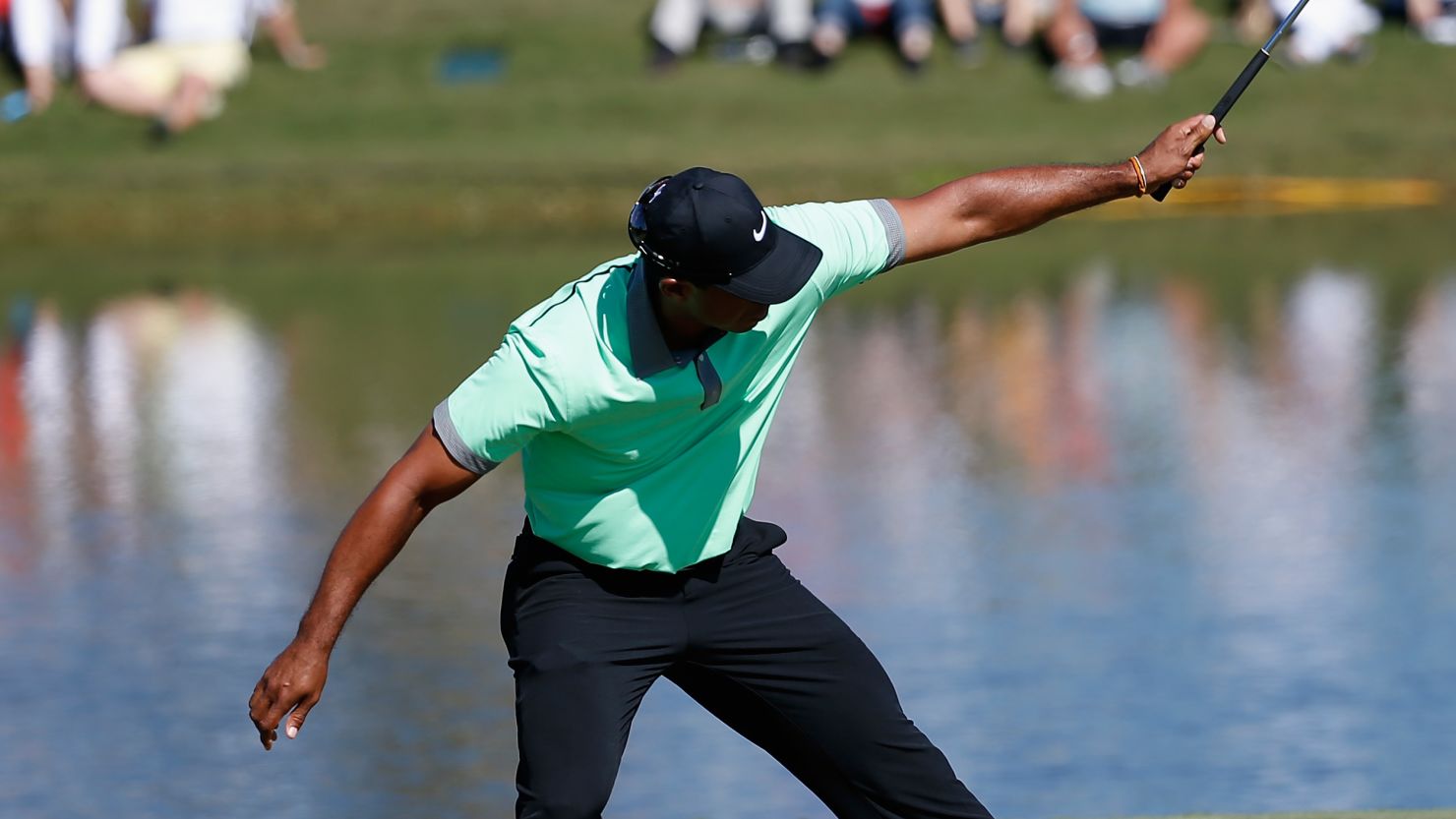 Tiger Woods wills his ball in the hole for a fine birdie on the 15th at Doral.
