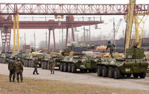 Ukrainian soldiers load armored personnel carriers into boxcars in the western Ukrainian city of Lviv on March 8.