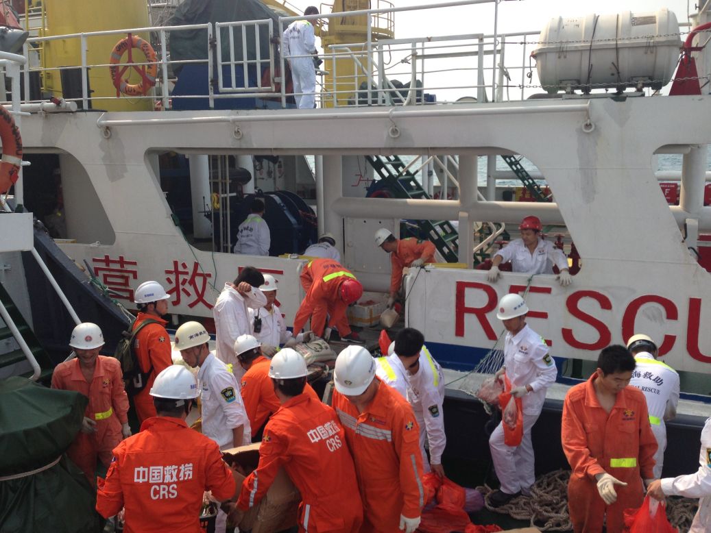 Members of a Chinese emergency response team board a rescue vessel at the port of Sanya in China's Hainan province on March 9, 2014.