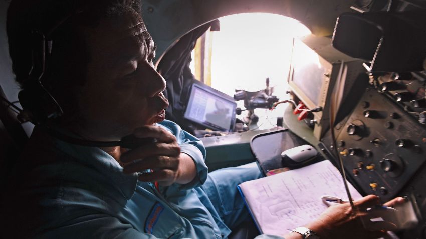 This picture taken from aboard a flying Soviet-made AN-26 used as a search aircraft by Vietnamese Air Force to look for missing Malaysia Airlines flight MH370, shows a crew member taking part in the search operations over the southern seas off Vietnam on March 9, 2014. Malaysia on March 9 launched a terror probe into the disappearance of a Malaysian Airlines passenger jet carrying 239 people the day before, investigating suspect passengers who boarded with stolen passports, as relatives begged for news of their loved ones. The United States sent the FBI to investigate after Malaysia Airlines flight MH370 vanished from radar early on March 8 somewhere at sea between Malaysia and Vietnam, but stressed there was no evidence of terrorism yet. AFP PHOTO / HOANG DINH NAMHOANG DINH NAM/AFP/Getty Images