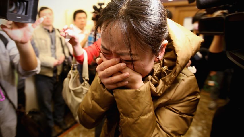 A relative of one of the Chinese passengers on board Flight 370 weeps at a Beijing hotel where families awaited information.