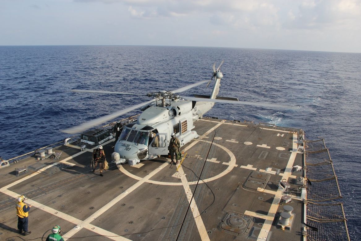 A U.S. Navy Seahawk helicopter lands aboard the USS Pinckney to change crews on March 9, 2014, before returning to search for the missing plane in the Gulf of Thailand.