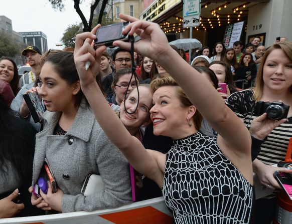Actress Tina Majorino ("Napoleon Dynamite") snaps a selfie with a fan on March 8 as she arrives for the premiere of "Veronica Mars." 