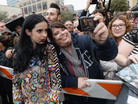 Actress Krysten Ritter ("Breaking Bad") poses with a fan before the "Veronica Mars" premiere on March 8. 
