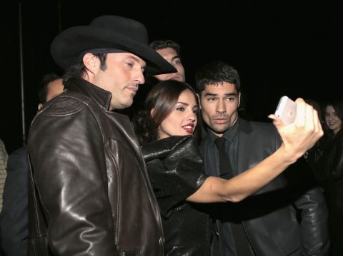Filmmaker Robert Rodriguez, left, poses with "From Dusk Till Dawn: The Series" actors Eiza Gonzalez and D.J. Cotrona on March 8. 