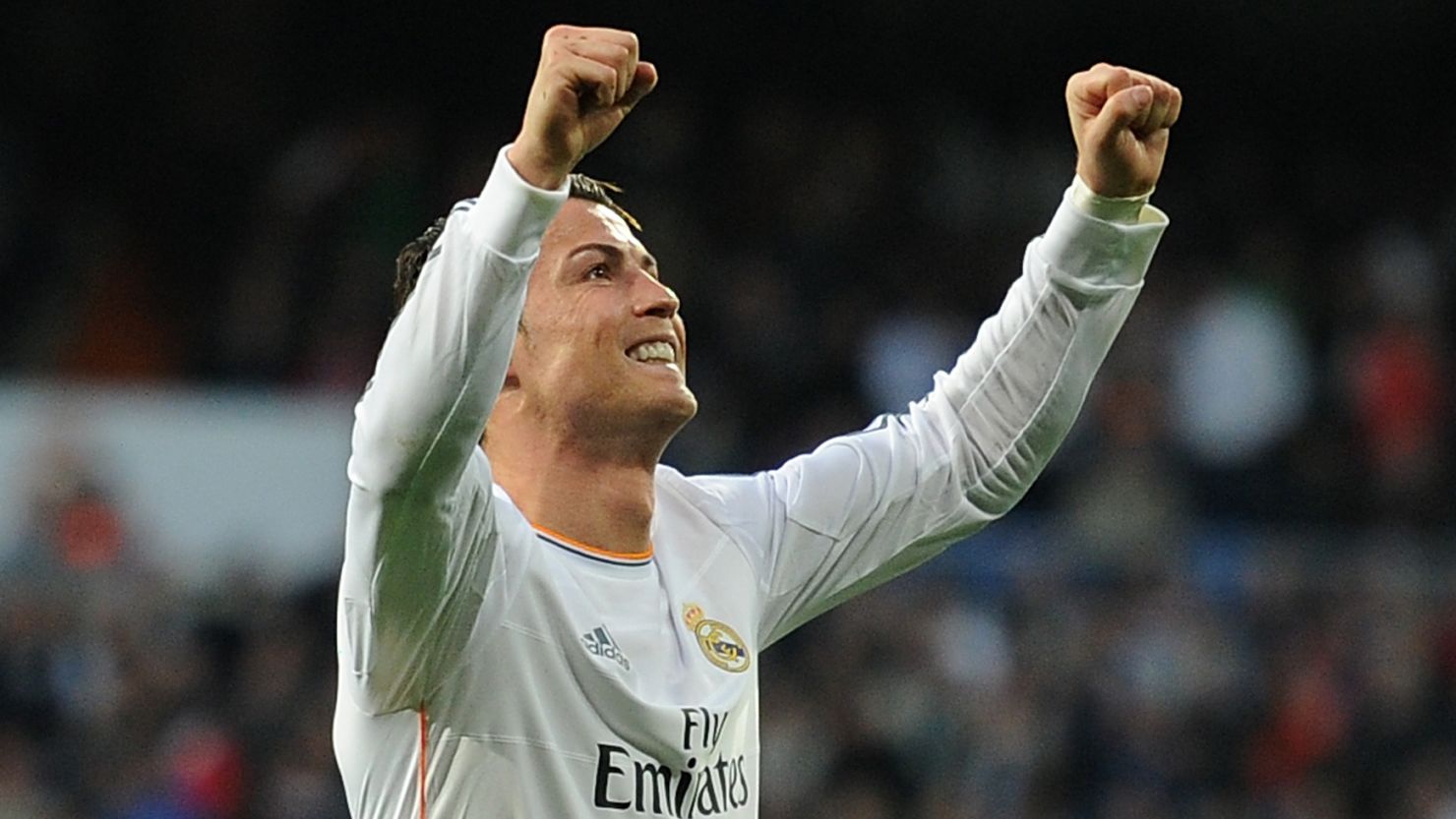 Cristiano Ronaldo raises his arms in triumph after scoring the opener for Real Madrid against Levante.
