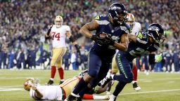 SEATTLE, WA - JANUARY 19: Defensive end Michael Bennett #72 of the Seattle Seahawks recovers a fumble by quarterback Colin Kaepernick #7 of the San Francisco 49ers and runs for 17-yards in the fourth quarter during the 2014 NFC Championship at CenturyLink Field on January 19, 2014 in Seattle, Washington. (Photo by Christian Petersen/Getty Images)