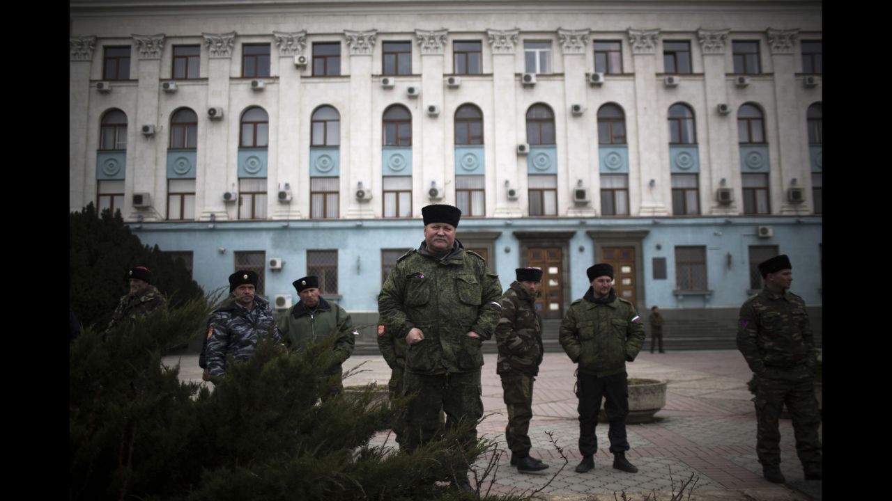 Cossacks and other pro-Russian forces stand guard outside a government building in Simferopol on Saturday, March 8.