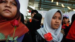 Members of a youth group deliver roses and prayers for relatives of passengers onboard Malaysia Airlines flight MH370 at Everley Hotel on March 10, 2014 in Kuala Lumpur, Malaysia.