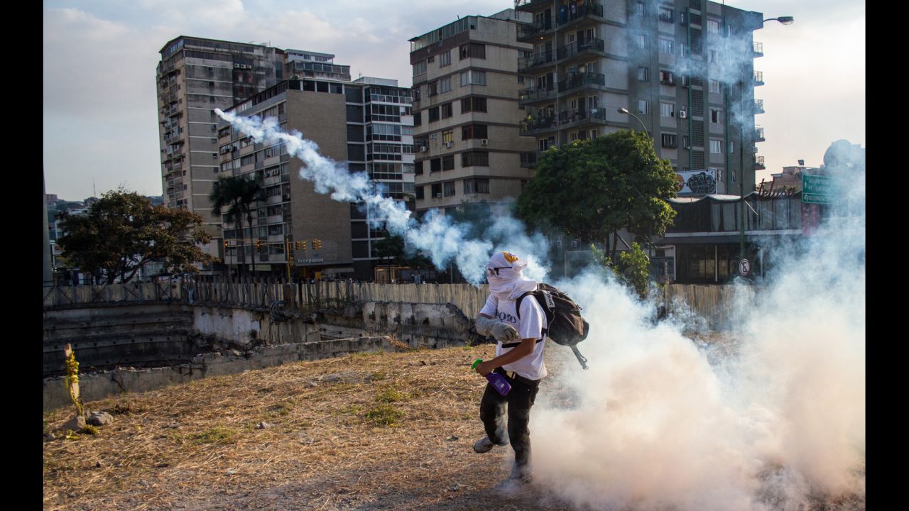 A protester throws a tear gas canister in Altamira, Venezuela, on Sunday, March 9.