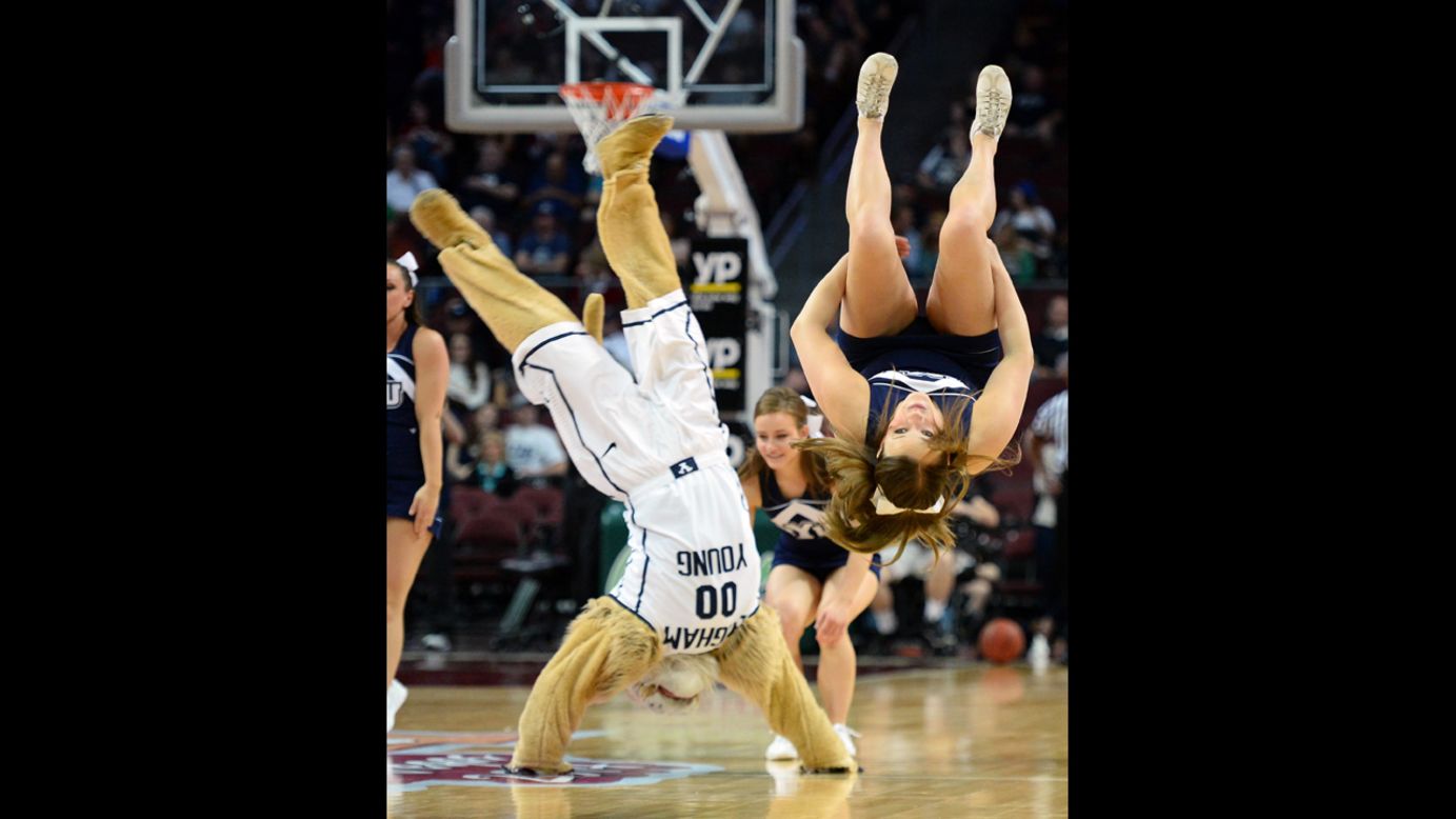 A cheerleader from Brigham Young University flips along with the school's mascot, Cosmo, at the West Coast Conference basketball tournament Saturday, March 8, in Las Vegas.