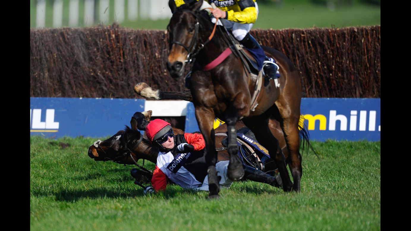 Adrian Doyle falls off Merrion Square during a steeplechase race Saturday, March 8, at Sandown Park in Esher, England.
