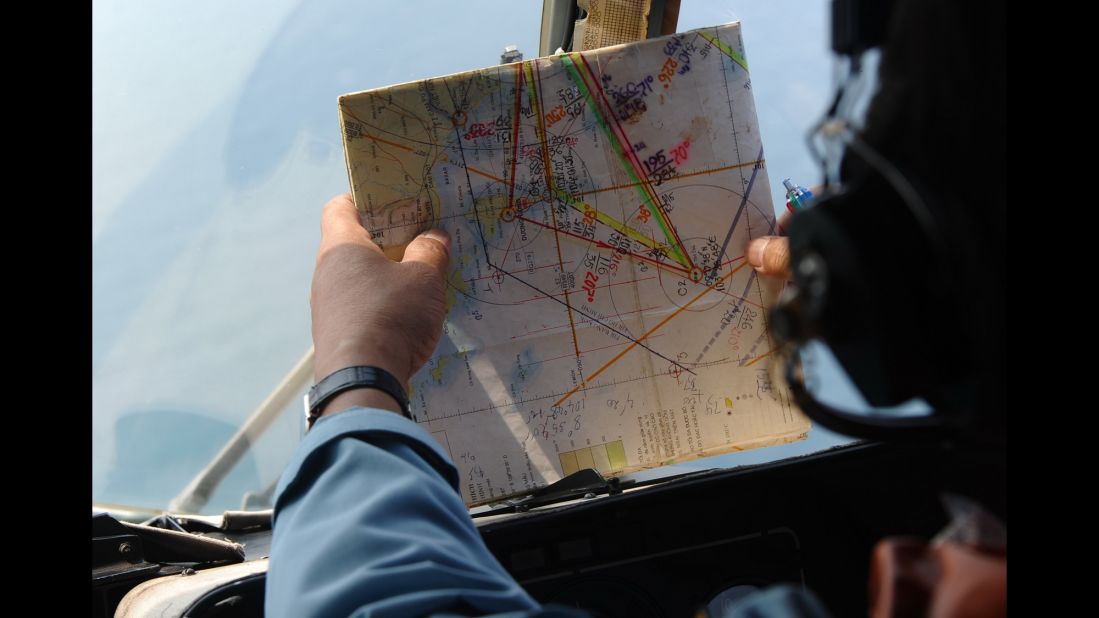 A member of the Vietnamese air force checks a map while searching for the missing plane on March 11, 2014.