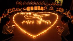This picture taken on March 10, 2014 shows students at Hailiang International School lighting candles to pray for the passengers on the missing Malaysia Airlines flight MH370 in Zhuji, in China's Zhejiang province.