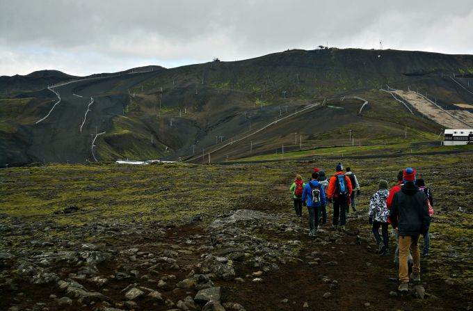 Hikers head to the ash-covered fields at Blafjoll, where Thrihnukagigur's magma chamber lies. The mountain range is only 20 kilometers southeast from Reykjavik. 