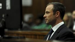 Oscar Pistorius sits in the dock as he listens to cross questioning about the events surrounding the shooting death of his girlfriend Reeva Steenkamp, in court during the second week of his trial in Pretoria, South Africa, Wedensday, March 12, 2014.
