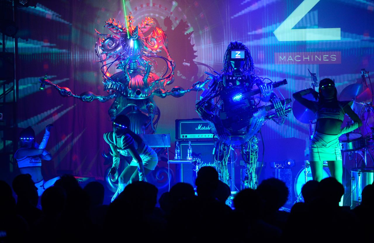 The band, created by engineers from the University of Tokyo, include a guitarist with 78 fingers, a drummer with 22 arms, and a keyboardist which shoots green lasers. 