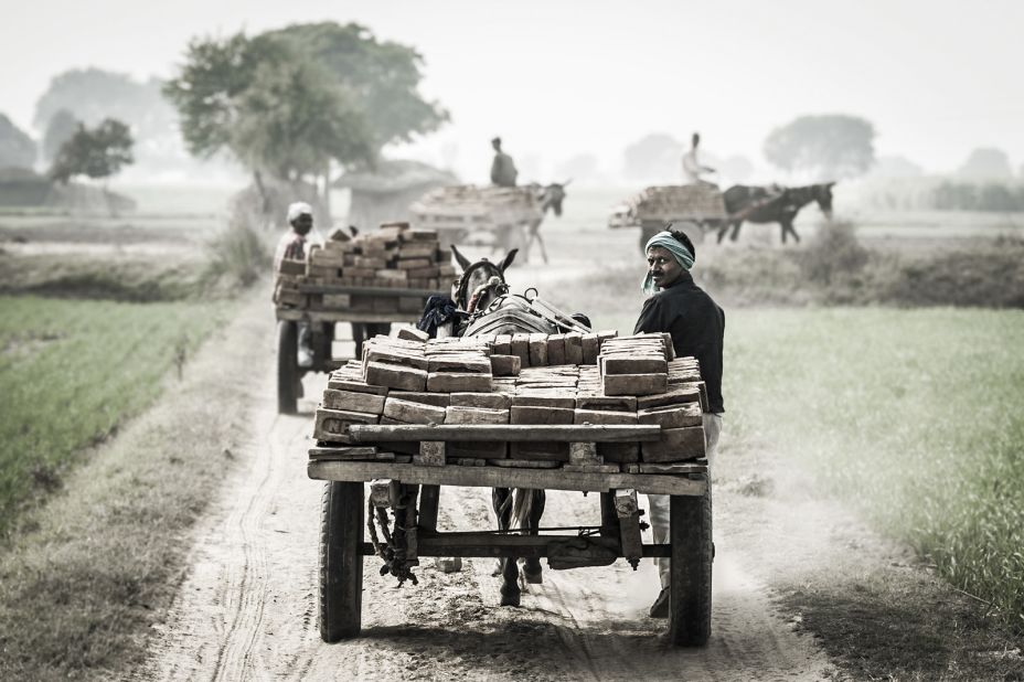 These images were part of a project by animal charity The Brooke -- here working mules and their drivers depart from a brick kiln close to Aligarh, an Indian city near Delhi.