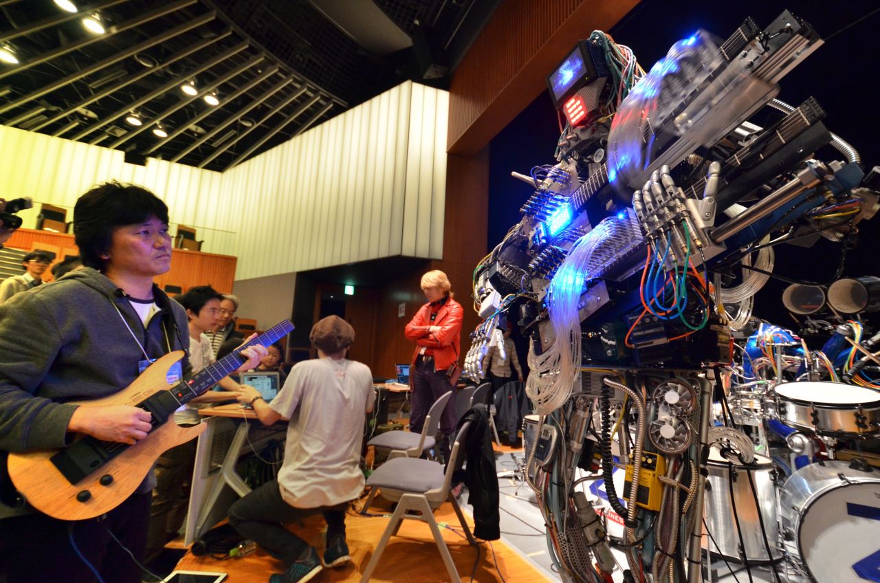 A man plays an electric guitar to control robot guitarist 'March' during a technology fair in Tokyo. What will the future hold for electronic music?