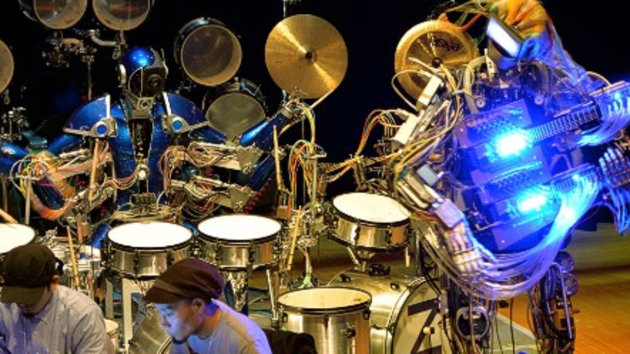 Visitors at a technology fair in Tokyo test out the giant guitarist. - (Getty Images)