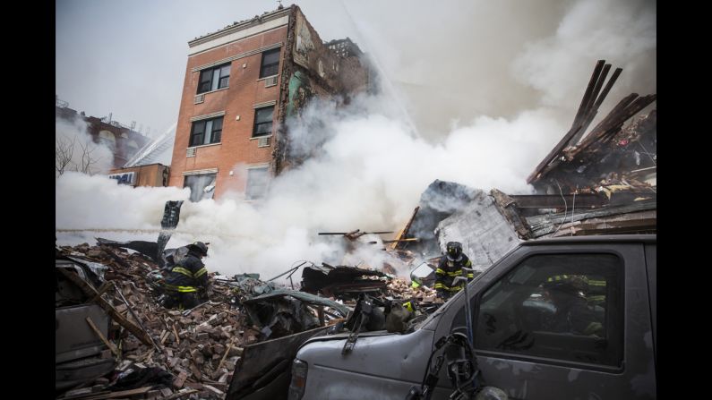 New York City firefighters examine the rubble after <a href="http://www.cnn.com/2014/03/12/us/gallery/harlem-explosion/index.html">a massive explosion and fire</a> leveled two apartment buildings in the East Harlem neighborhood of Manhattan on Wednesday, March 12.