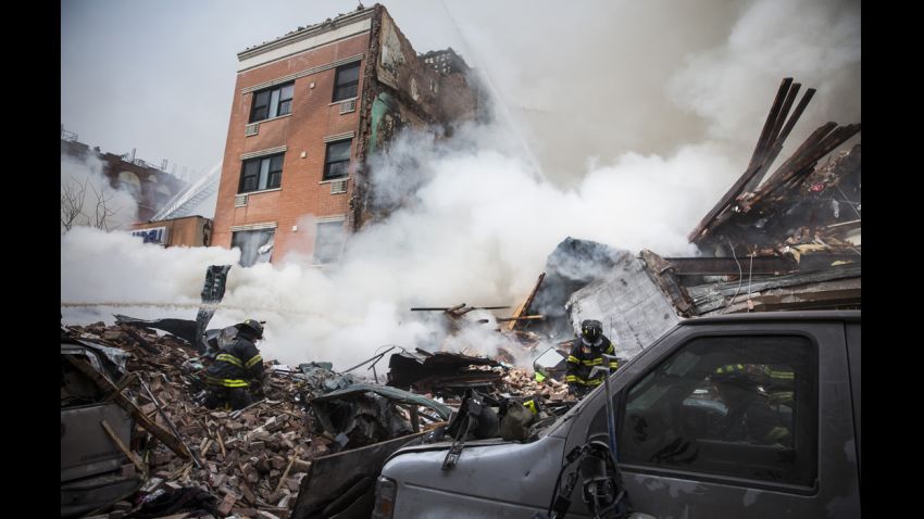 NEW YORK, NY - MARCH 12: Heavy smoke pours from the debris as the Fire Department of New York (FDNY) responds to a 5-alarm fire and building collapse at 1646 Park Ave in the Harlem neighborhood of Manhattan March 12, 2014 in New York City. Reports of an explosion were heard before the collapse of two multiple-dwelling buildings that left at least 11 injured. (Photo by Andrew Burton/Getty Images)