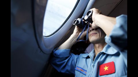 A Vietnamese military official looks out an aircraft window during search operations March 13, 2014.